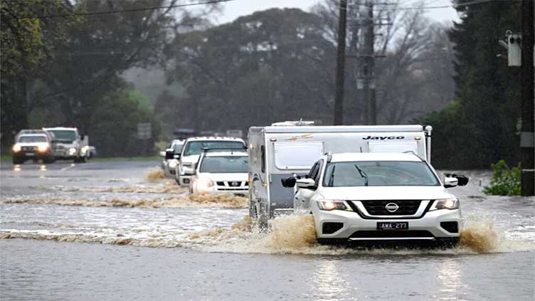 Thousands urged to higher ground as Australia battles floods